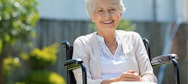 woman in wheelchair smiling outdoors Image