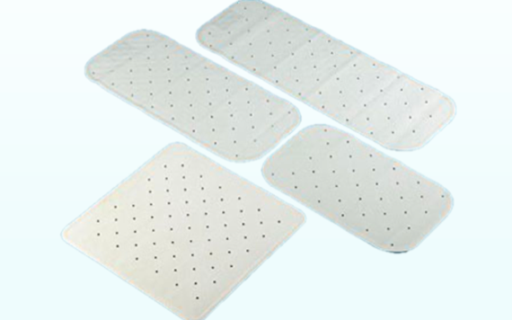 Four white bandages with small black dots on a light blue background. Each bandage is a different size.