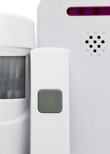 A motion sensor set with three white devices: a curved sensor, a rectangular remote with a grey button, and a square base unit with purple lights. Image