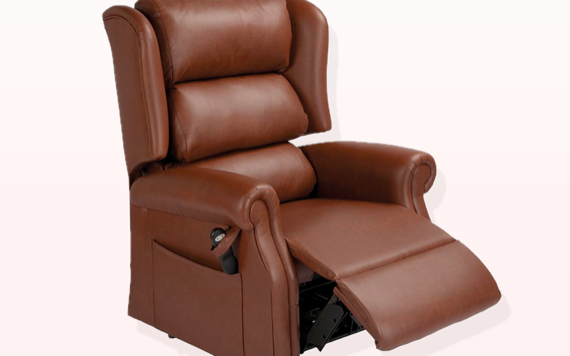A brown leather recliner chair with a high back, plush armrests, and an extended footrest. The background is soft pink.
