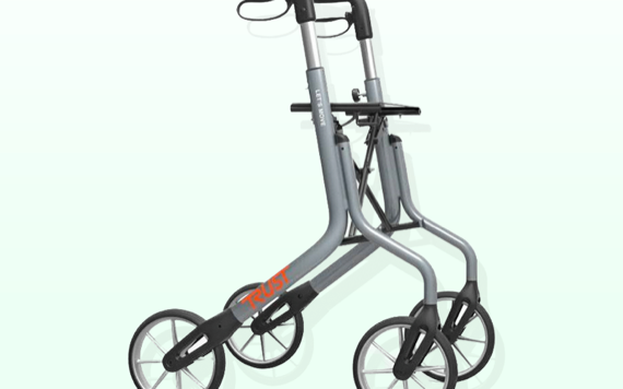 A lightweight, foldable gray walker with four black wheels and ergonomic handles. The word TRUST is visible on the frame.