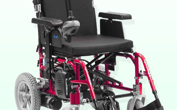 An electric wheelchair with a black cushioned seat, joystick on the right armrest, large rear wheels, and adjustable footrests.