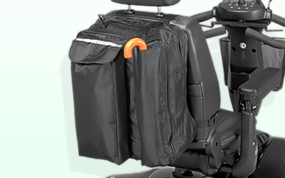 A black scooter with a headrest seat, small front basket, and a black storage bag with compartments and an orange handle on the back. Image