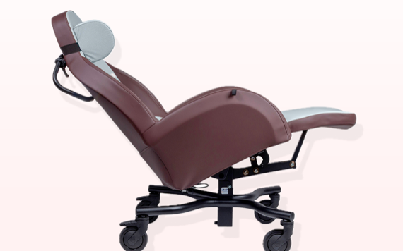 A reclining chair with a brown leather seat, light gray headrest, and black wheels, against a soft gradient background.