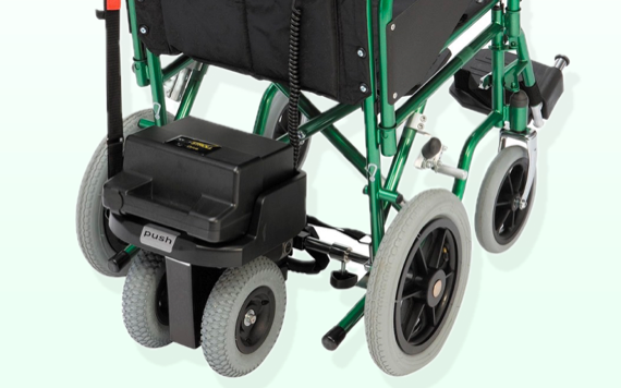 A green and black motorized wheelchairs base with large black rear wheels, smaller gray front wheels, and a visible motor at the back.
