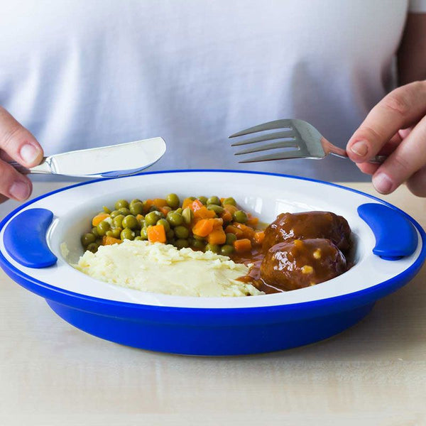 ORNAMIN Keep Warm Plate with mashed potatoes, peas with carrots and meatballs in sauce, person holding fork and knife, in use view.
