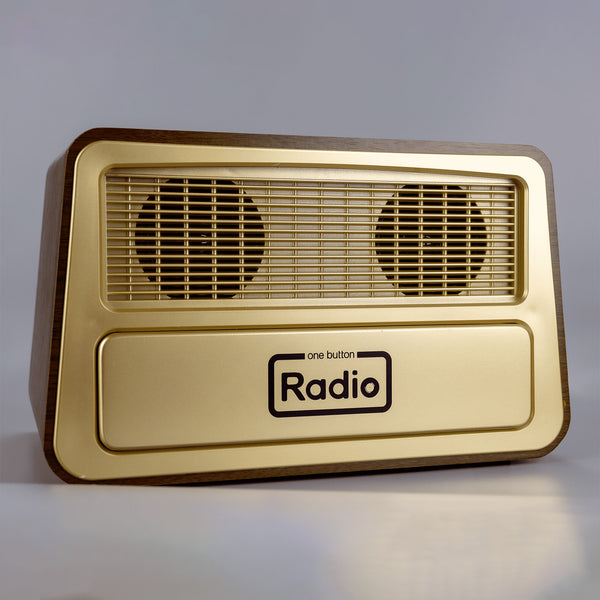 Gold one-button dementia radio with vintage look, two speaker grills and simple controls, front view.