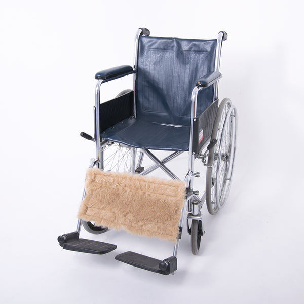 Wheelchair calf strap with a tan wool footrest cover on a plain white background, front view.