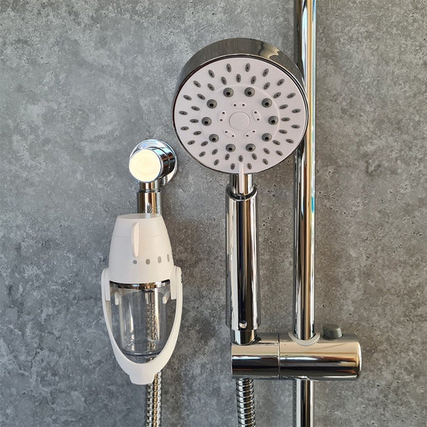 ShowerSpaah and Bubble showerhead set mounted on a grey tiled bathroom wall, front view.