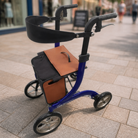 Integrity Taurus Premium Rollator with a brown bag on a city pavement, front view.