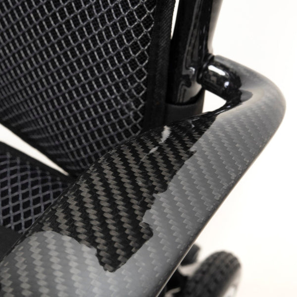 Lightweight carbon fibre armrest and mesh backrest on Drive AeroCarbon Powerchair, close-up.