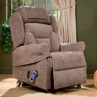 Monterey Royale Five Motor Wide Riser Recliner Chair in cocoa, positioned by a window with beige curtains and green wall, angled view.