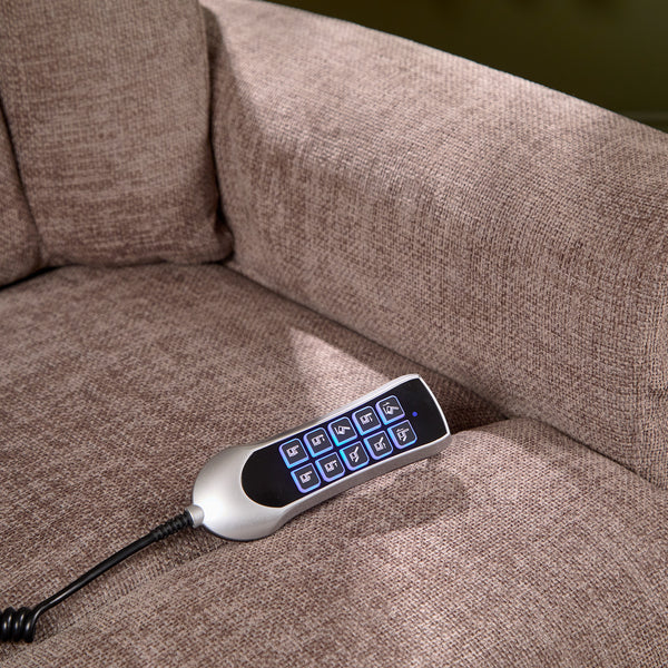 Remote with blue buttons on Motion Healthcare Monterey Royale Five Motor Wide Riser Recliner Chair, angled view.