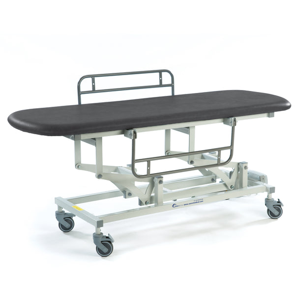 Black electric changing table with cushioned top, metal frame, safety rails, and wheels, height adjustable, side view.