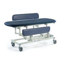 Sterling Electric Changing Table in dark blue with adjustable backrest, split leg support and wheels, side view.