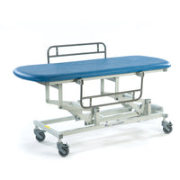 Sky blue electric changing table with metal frame and four wheels, shown from the side.