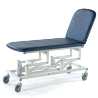 Dark blue electric 2 section medical couch with adjustable metal frame and wheels, side view.