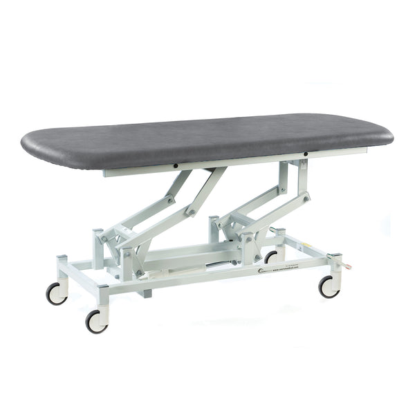 Dark grey electric therapy hygiene table with padded top, white wheeled frame, height adjustable, clinic equipment, side view.