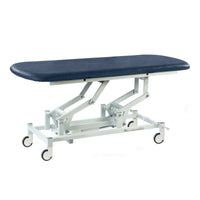 Dark blue SEERS Medical hydraulic therapy hygiene table with padded top and adjustable height, side view.
