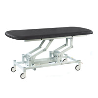 SEERS Medical electric therapy hygiene table with black cushioned top, white frame and wheels, clinic equipment, side view.