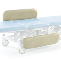 Cream SEERS Medical hydraulic therapy hygiene table with adjustable height, shown from side view.