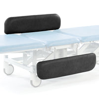 Electric therapy hygiene table with light blue cushion, black supports, wheels, and electric height adjustment, side view.