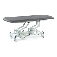 Dark grey SEERS Medical electric therapy hygiene table with padded top, metal frame, wheels, adjustable height, side view.
