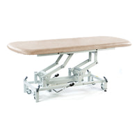 Cream hydraulic therapy hygiene table with height adjustment, metal frame and wheels, clinical design, side view.