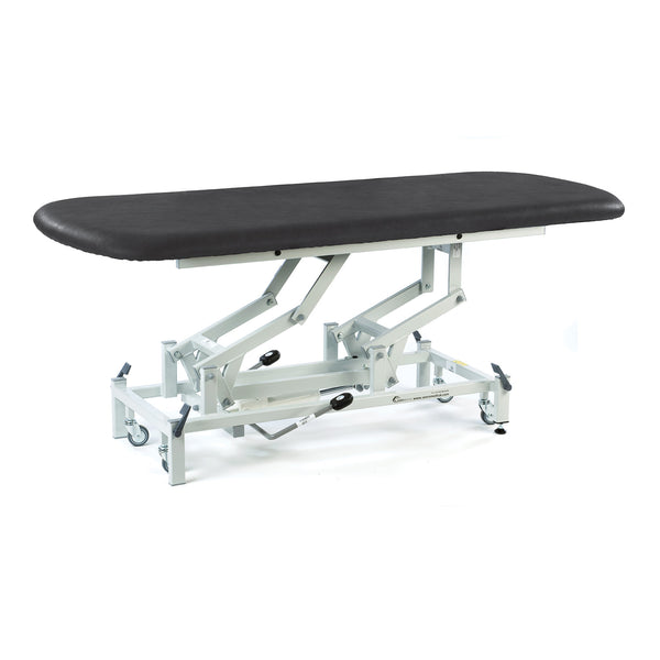 Black electric therapy hygiene table with white metal frame and wheels, height adjustable, side view.