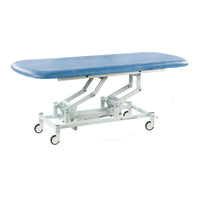 Hydraulic therapy hygiene table with sky blue top and white wheeled frame, clinic equipment, side view.