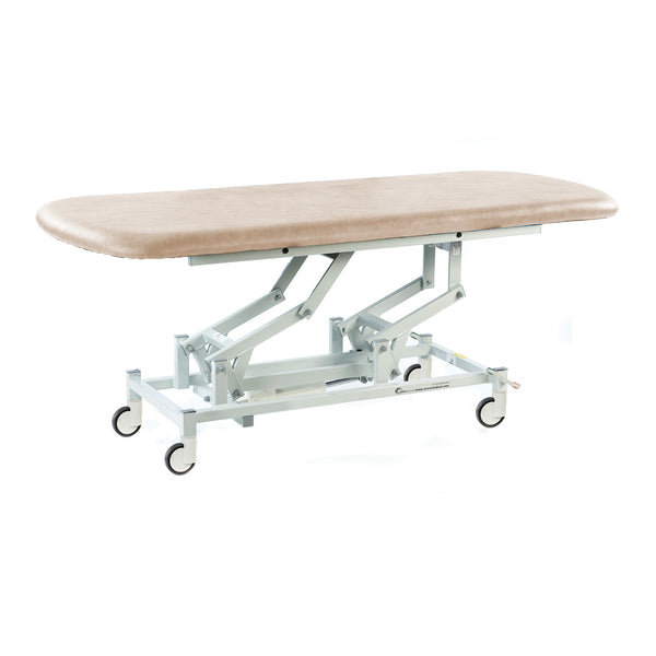 Cream-coloured hydraulic therapy hygiene table with height adjustment and caster wheels, shown in a side view.