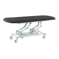 Black electric therapy hygiene table with cushioned top, white frame and wheels, shown from side view.