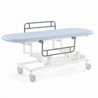 Black electric therapy hygiene table, height-adjustable with wheels, shown from side view.