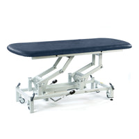 Dark blue hydraulic therapy hygiene table with white base, wheels, and height adjustment, front angle view.
