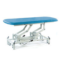 Hydraulic therapy hygiene table with adjustable height and white wheeled frame, clinic furniture, side view.