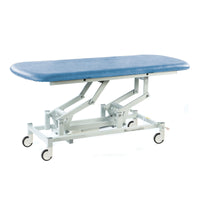 Sky blue hydraulic therapy hygiene table with white frame and wheels, designed for clinics, side view.