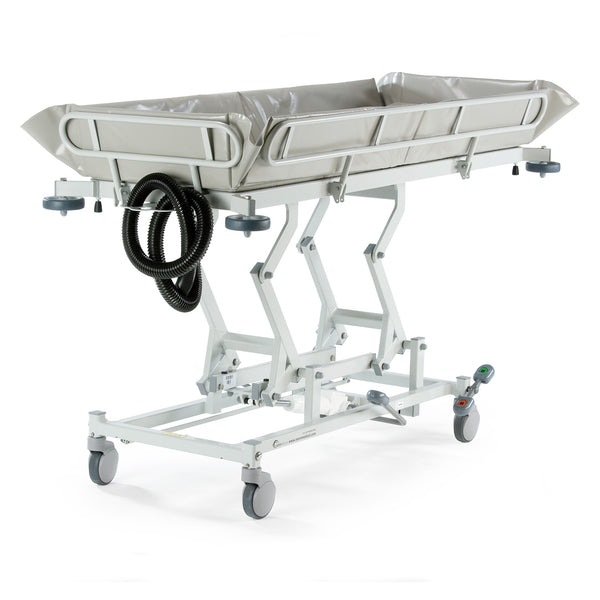 Hydraulic shower trolley with side rails, wheels, and drainage hoses for patient transport or bathing, side view.