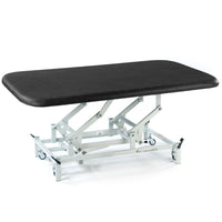 SEERS Medical electric therapy mat table, height-adjustable with cushioned top and white wheeled frame, side view.