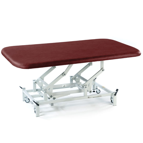 Burgundy electric therapy mat table with white wheeled frame, suitable for physiotherapy, side view.