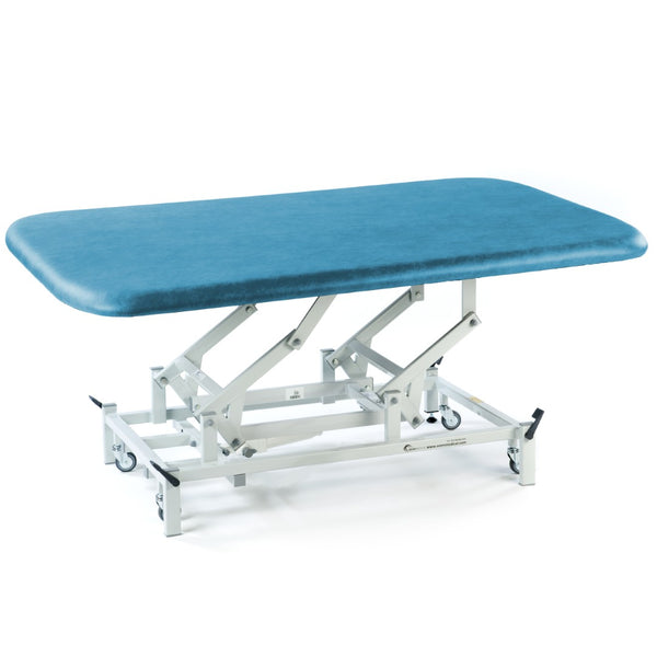 SEERS Medical Electric Therapy Mat Table, height-adjustable with wheeled frame, side view.