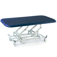 Dark blue electric therapy mat table with height adjustment and white wheeled base, side view.