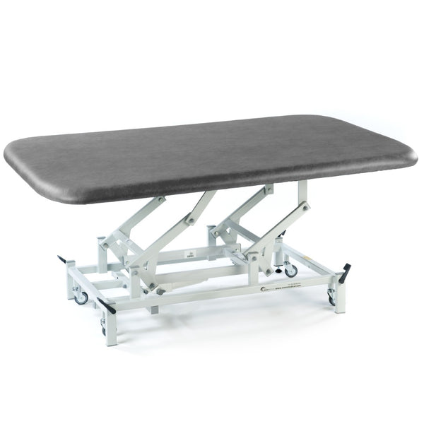 SEERS Medical Electric Therapy Mat Table with height adjustment, sturdy frame and wheels, medical use, side view.