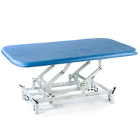 SEERS Medical Electric Therapy Mat Table with adjustable height and white wheeled base, side view.