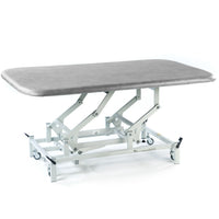 SEERS Medical Electric Therapy Mat Table, height-adjustable with padded top and metal frame on wheels, side view.
