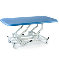 SEERS Medical Hydraulic Therapy Mat Table with cushioned surface and white wheeled frame, side view.