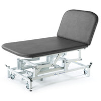 SEERS Medical Electric Therapy Bobath Couch with adjustable height, cushioned top and wheels, side view.