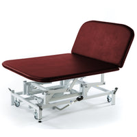 Burgundy SEERS Medical hydraulic therapy Bobath couch with metal frame and wheels, side view.