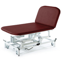 Burgundy hydraulic therapy Bobath couch with padded backrest, metal frame, and adjustable height, side view.