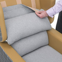 Person lifting pressure relief cushion on Repose Seating Harlem Porter Express Chair, side view.