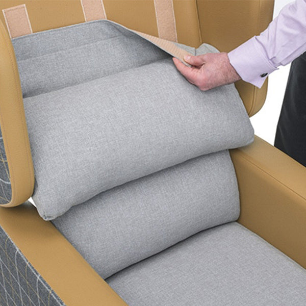 Person lifting pressure relief cushion on Repose Seating Harlem Porter Express Chair, side view.